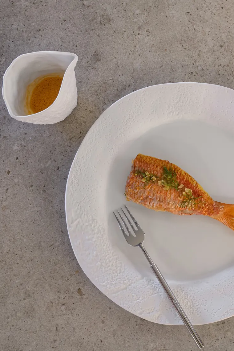 Whole red mullet served on a stone table