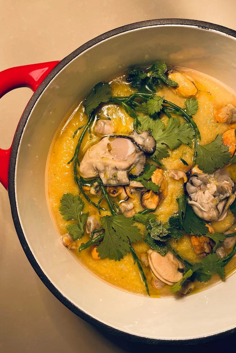 Clams, oysters and coriander in a red casserole