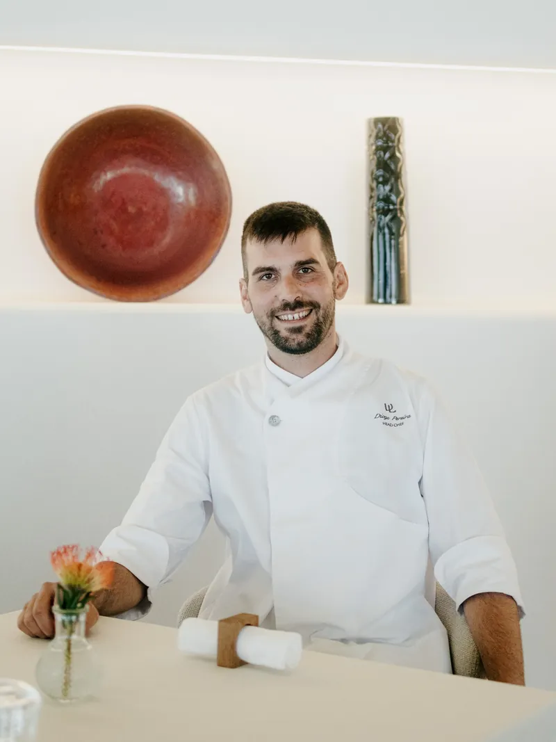 Chef Diogo Pereira seated in the Coral dining room