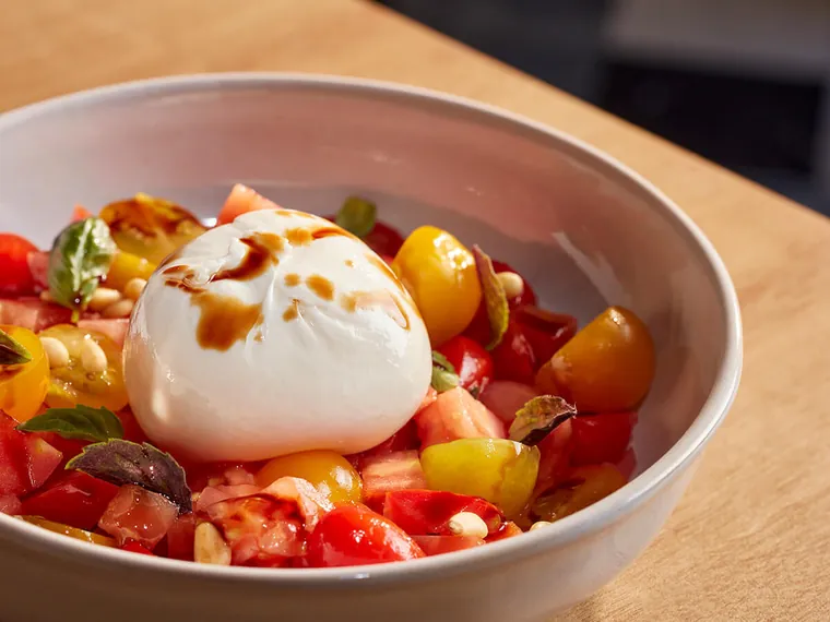 Burrata with heirloom tomatoes, basil and pine nuts