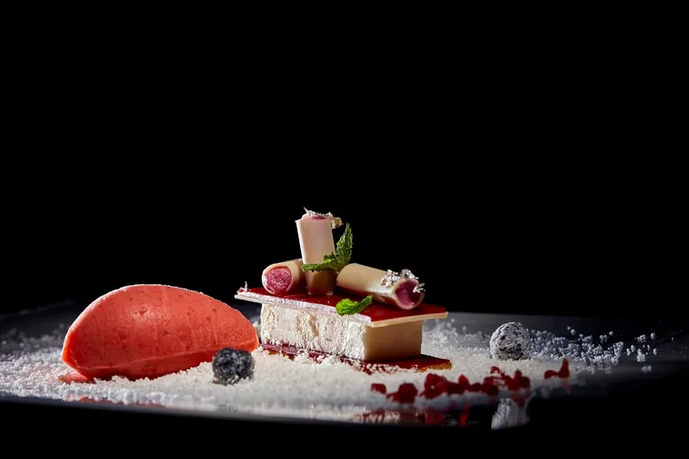 Caviar, radish and cauliflower on a white plate