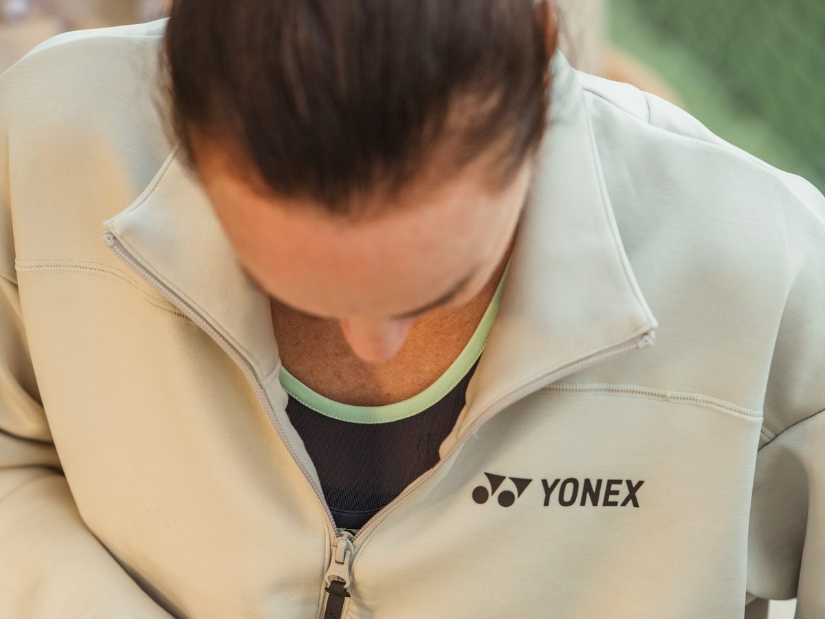 Martina Hingis signing a tennis ball