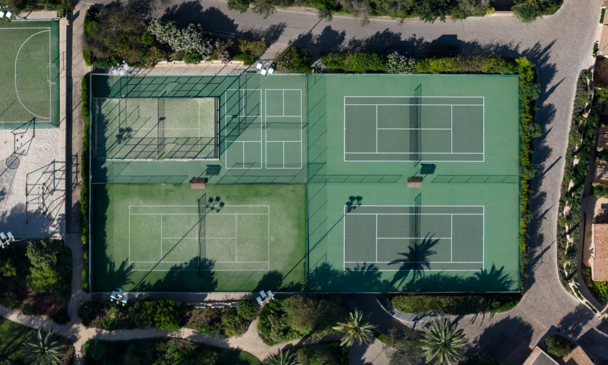 The tennis courts of Vilalara among the pines, seen from above