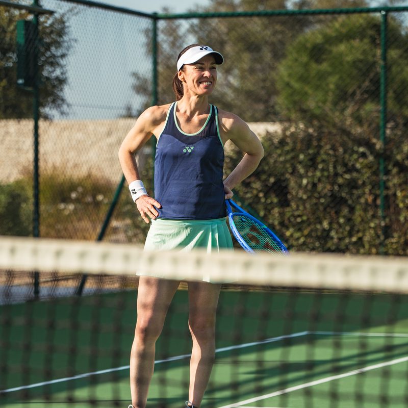 Martina Hingis at the net, hands on her hips